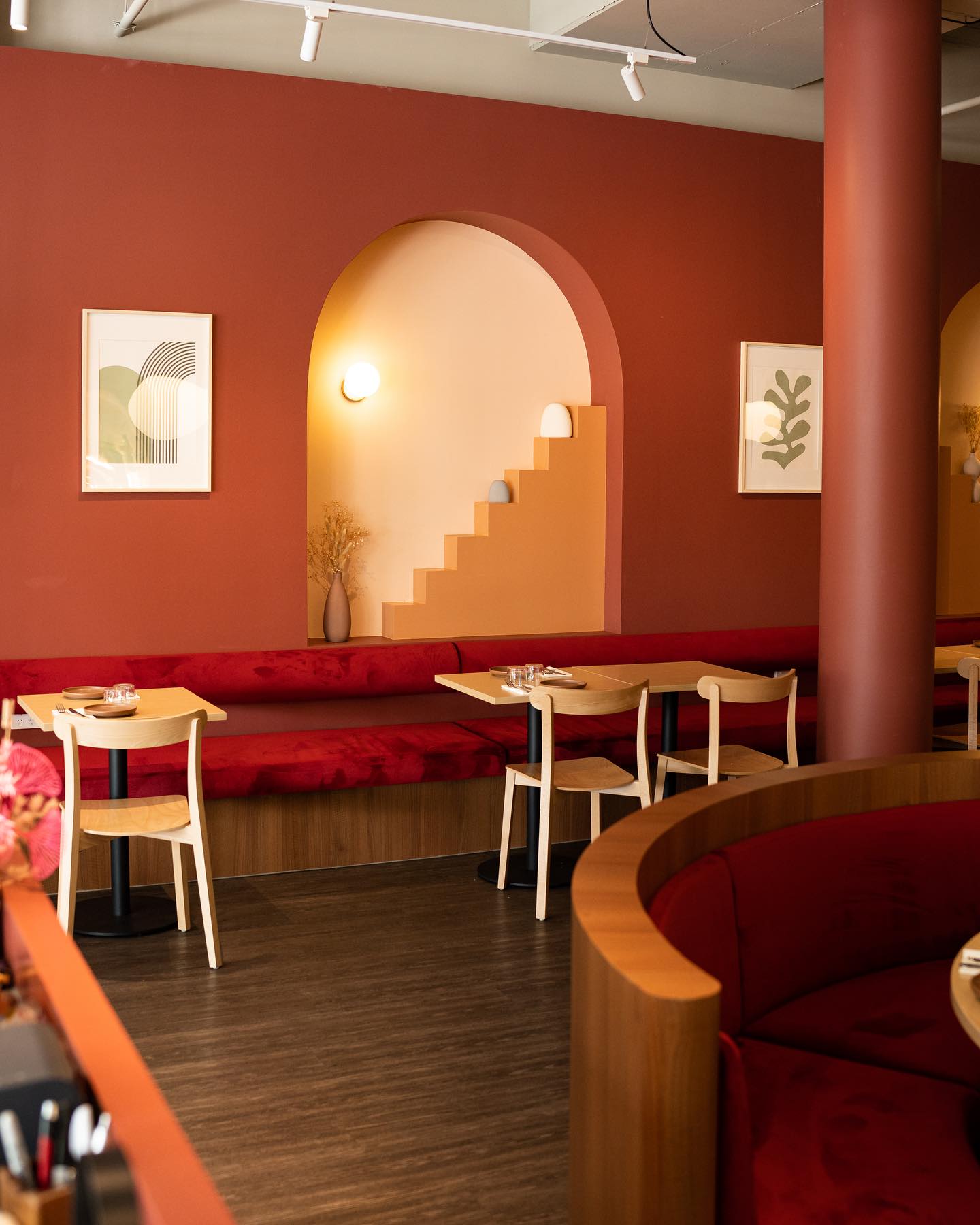 KOYO dining room interior with arched recess and red banquette seating
